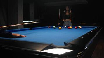 Couple is playing billiards, man breaks the initial position of the balls in the form of triangle with a strong powerful blow video