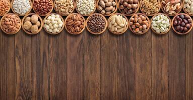 collection nuts and seeds on wooden table background with empty space. photo