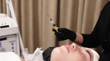 Side view portrait of young relaxed woman on procedure for improvements skin. Concept of special masks and creams for moisturizing. Self care spa concept. Advertising of cosmetology, cleanliness. video