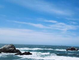 A view of the ocean from a rocky shore photo