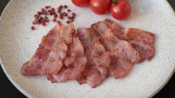 Delicious crispy bacon grilled with salt and spices as an ingredient for a nutritious breakfast. video