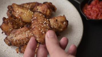 Grilled chicken wings with salt, spices on a dark concrete background video