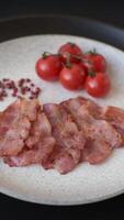Delicious crispy bacon grilled with salt and spices as an ingredient for a nutritious breakfast. video