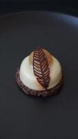 Sweet tart with pear lemon mousse cream and chocolate cake base on a dark concrete background video