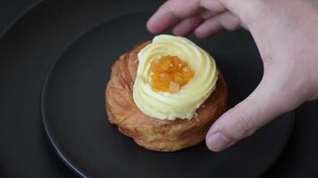 Sweet dessert danish with raisins, cream and pear filling on a dark concrete background video