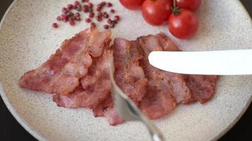 Delicious crispy bacon grilled with salt and spices as an ingredient for a nutritious breakfast. video