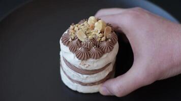 Sweet puff tart with meringue, cream and nuts on a dark concrete background video