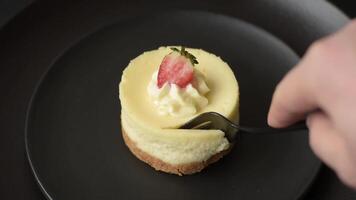 Sweet cheesecake tart with strawberries and mascarpone on a dark concrete background video