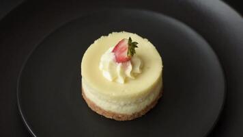 Sweet cheesecake tart with strawberries and mascarpone on a dark concrete background video
