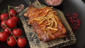 Pork or beef ribs with salt, spices and herbs baked on the grill on a dark concrete background video