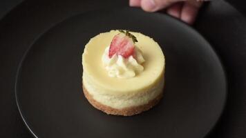 Sweet cheesecake tart with strawberries and mascarpone on a dark concrete background video