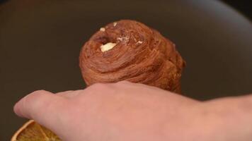 Sweet craffin made from puff pastry with Swiss meringue on a dark textured background video