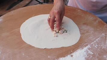 Hands skillfully preparing the dough on a rustic wooden surface, ready for baking video