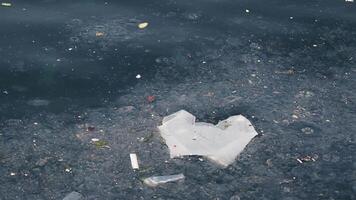 The surface of the water is contaminated with various debris and pollution elements present video