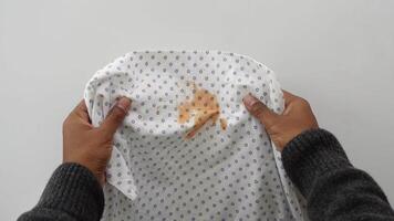 A Stained Hospital Gown with Peanut Butter Displayed on a White Background Setting video