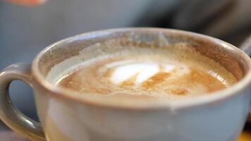 white sugar pouring from a in a paper packet on a coffee cup video