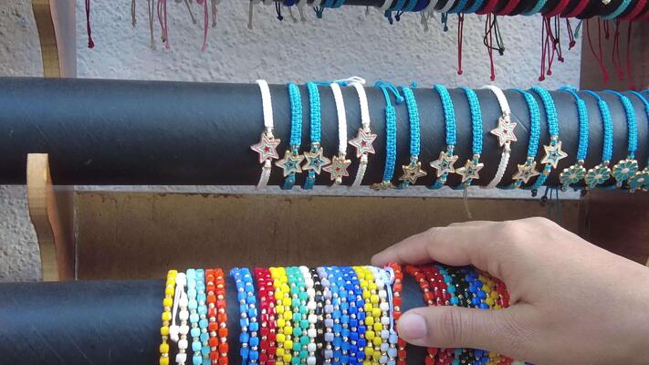A Vibrant Array of Colorful Handmade Bracelets Elegantly Displayed for Sale at the Market