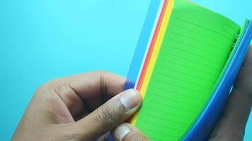hand turning pages of colorful notepad video