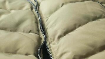 A Detailed CloseUp Image of a Warm Puffer Jacket Featuring Zipper Design Elements video