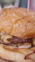 Enjoy a Delicious and Juicy Cheeseburger topped with Onion and served on a Sesame Seed Bun video