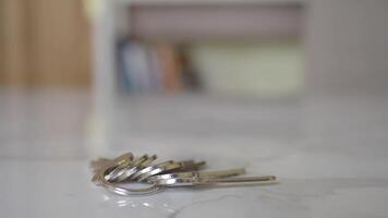 house keys on the ring on table in a room. To forget keys at home concept , video