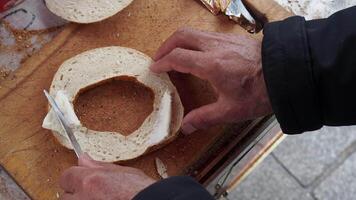spreading butter on Turkish Bagel Simit on table video