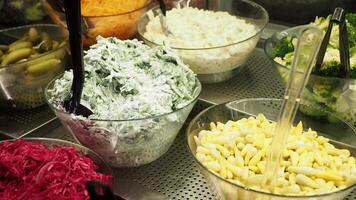 A Variety of Assorted Fresh Salads Displayed in Clear Bowls on a Beautiful Buffet Table video