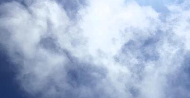 A plane flying through the sky with clouds photo