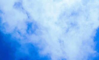 A plane flying through the air with a cloud in the background photo