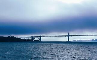 A large bridge over water with a large body of water in the background photo