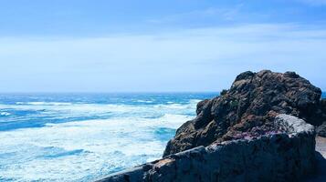 A rocky cliff overlooking the ocean photo