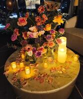 A table with candles and flowers on it photo