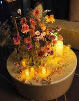A table with flowers and candles on it photo