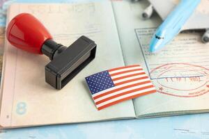 US America flag with approved Stamp visa and passport document to immigration at airport in country. photo