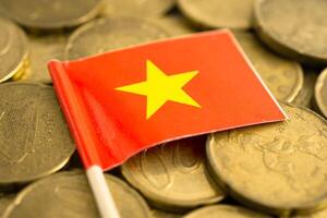 Vietnam flag on gold coins, finance and banking business. photo