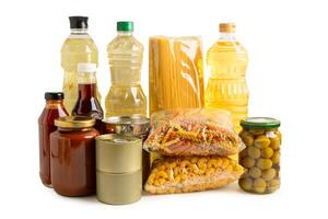 Foodstuff for donation isolated on white background with clipping path, storage and delivery. Various food, pasta, cooking oil and canned food. photo