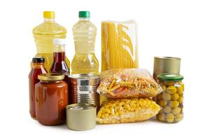 Foodstuff for donation isolated on white background with clipping path, storage and delivery. Various food, pasta, cooking oil and canned food. photo