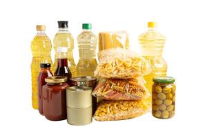 Foodstuff for donation isolated on white background with clipping path, storage and delivery. Various food, pasta, cooking oil and canned food. photo