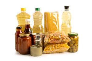 Foodstuff for donation isolated on white background with clipping path, storage and delivery. Various food, pasta, cooking oil and canned food. photo