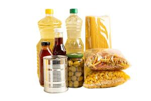 Foodstuff for donation isolated on white background with clipping path, storage and delivery. Various food, pasta, cooking oil and canned food. photo