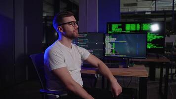 Portrait Of Programmer In Dark IT Office, Sitting At Desk video