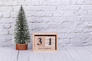Christmas tree, December 31 calendar, gifts, snowman on the background of a brick wall photo