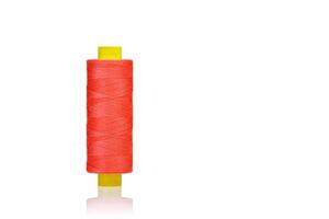 skein of orange color thread macro on a white background photo