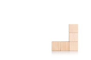 wooden cubes in the form of a ladder with a hand on an isolate white background photo