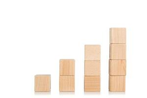 wooden cubes in the form of a ladder with a hand on an isolate white background photo