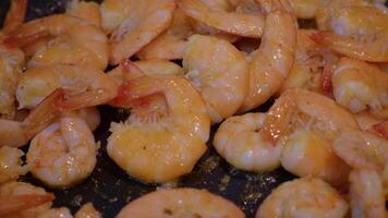 Close-up shot of shrimps getting cooked in a pan with butter. video
