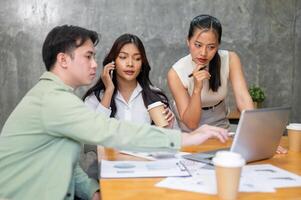 A group of professional Asian businesspeople is in a meeting, planning for the upcoming project. photo
