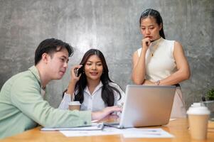 A group of professional Asian businesspeople is in a meeting, planning for the upcoming project. photo