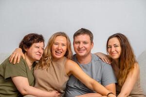 Portrait of a married couple with relatives on the sofa photo
