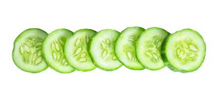 Cucumber slices in a row isolated on white background photo